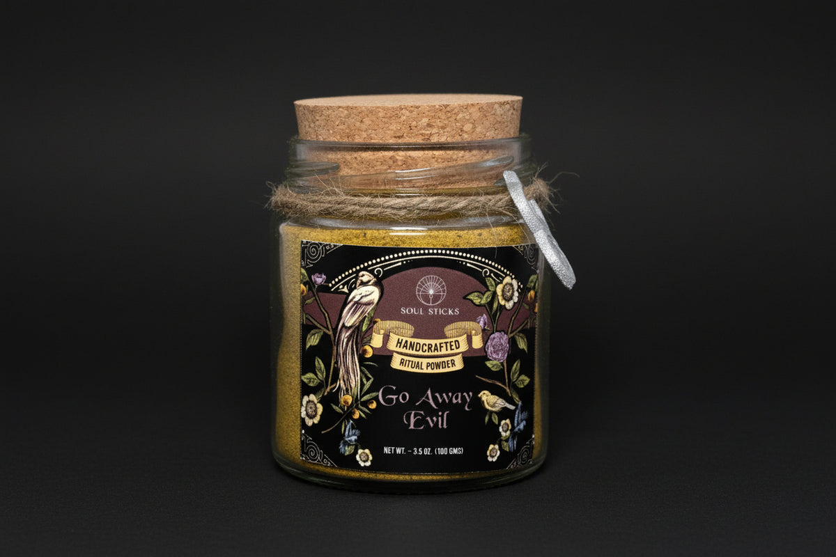 Jar of 'Go Away Evil' ritual powder with decorative label and cork lid on a white background