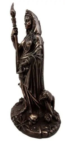Bronze statue of a figure holding a staff on a white background