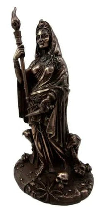 Bronze statue of a figure holding a staff on a white background