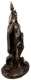 Bronze statue of a figure with a candle on a white background