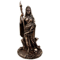 Bronze statue of a figure holding a staff on a white background