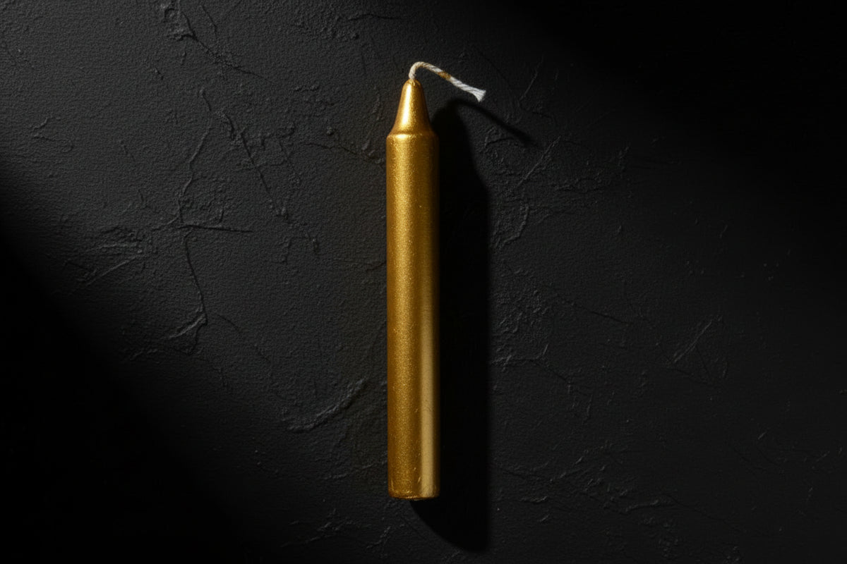 Gold candle on a white background