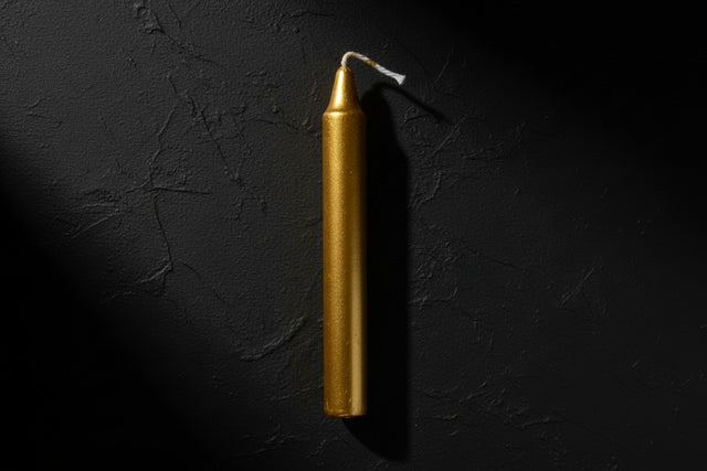 Gold candle on a white background