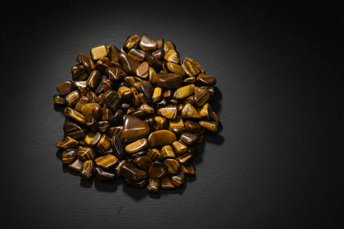 Polished golden-brown Tiger Eye tumbled stones with chatoyant banding