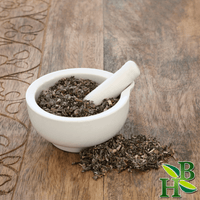 Mortar and pestle with dried herbs on a wooden surface, featuring a brand logo in the corner.