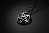 Pentagram pendant on a cord against a wooden background