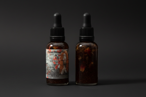 Bottle of Oil with dropper on a dark background.