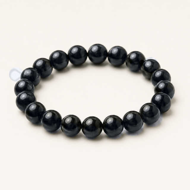 Representative polished beaded stretch bracelet sold under the Heterolite label; mineral identity, treatment, dark gray-to-black color, metallic-looking areas, bead size, fit, and exact condition vary