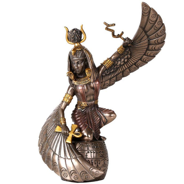 Statue of a winged Egyptian goddess on a white background