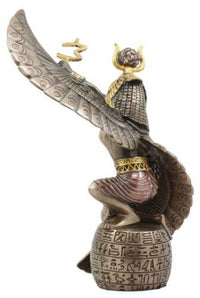 Decorative figurine of a winged creature with hieroglyphics on a white background