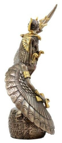 Decorative figurine of a winged creature with gold accents on a white background