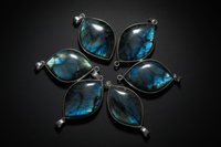 Representative Labradorite pendant assortment showing angle-dependent flash; pendant shape, color, and brightness vary