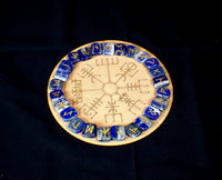 A circular lapis lazuli rune board with a golden pyrite vein pattern and Elder Futhark runic inscriptions.