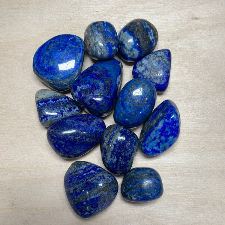 Collection of blue stones on a beige surface