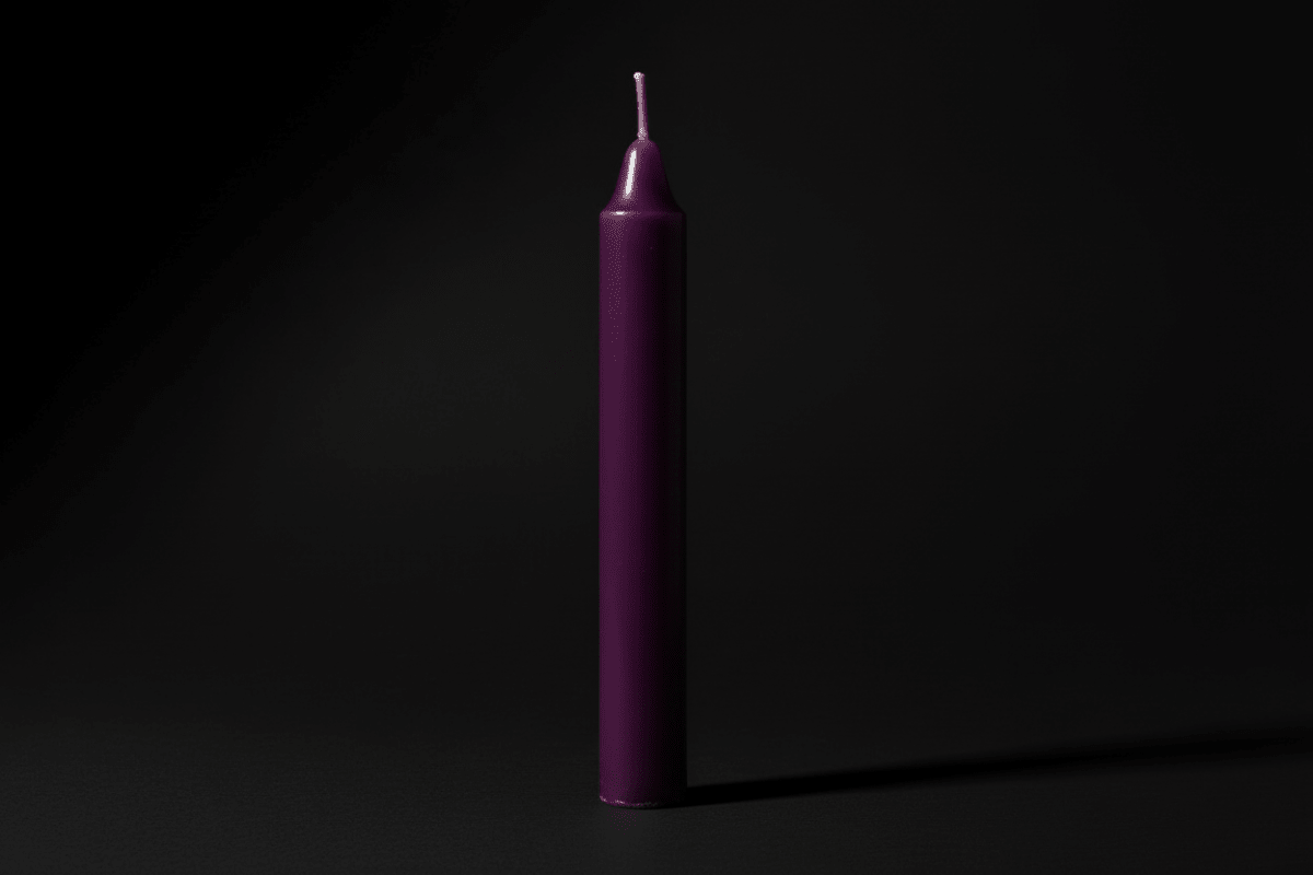 Lavender chime candle on a plain background