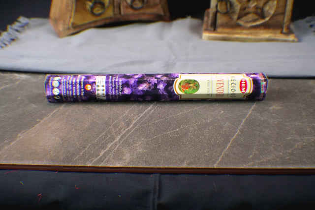 A pack of Lavender incense sticks on a wooden surface, with a purple label featuring floral graphics.