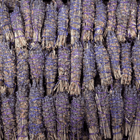 Bundles of lavender smudge sticks tied with purple ribbons.