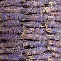 Stack of bundled sticks with purple string ties
