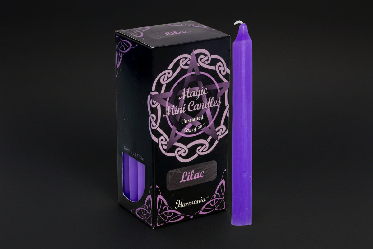 Purple candle next to its packaging with 'Harmonia' branding on a white background