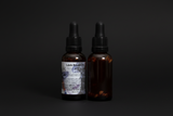 Lilith oil in a bottle with a dropper on a black background,