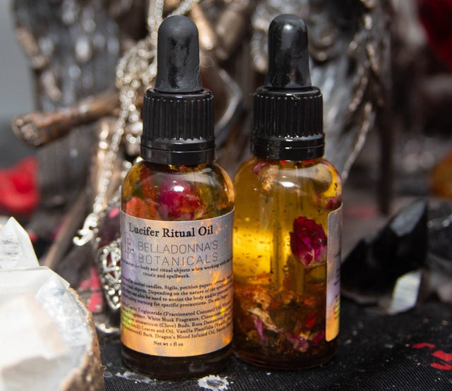 Two bottles of Locifer Ritual Oil with botanicals on a dark background