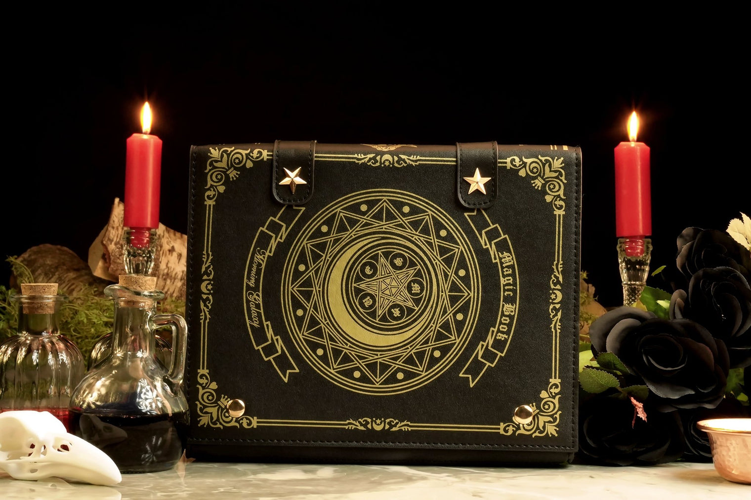 A gothic-style handbag designed to resemble a spellbook, featuring a crescent moon and pentacle symbols. The bag is displayed with candles and a dark backdrop, emphasizing its mystical and elegant design.