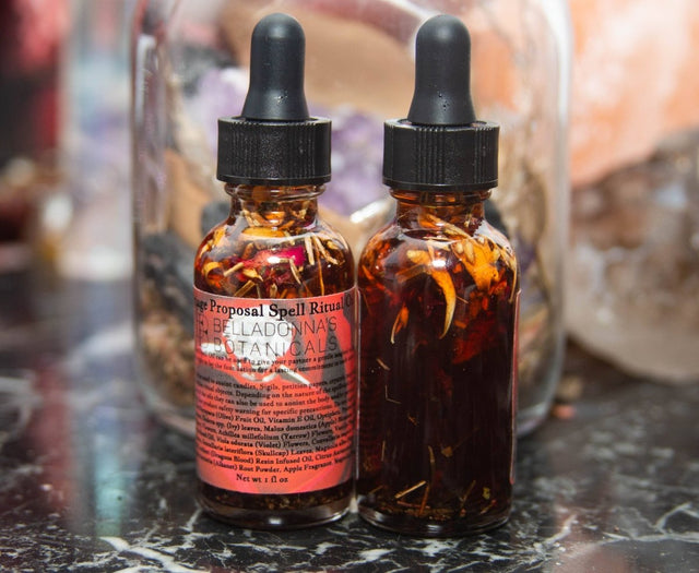 Two bottles with dropper caps on a dark surface with a blurred background