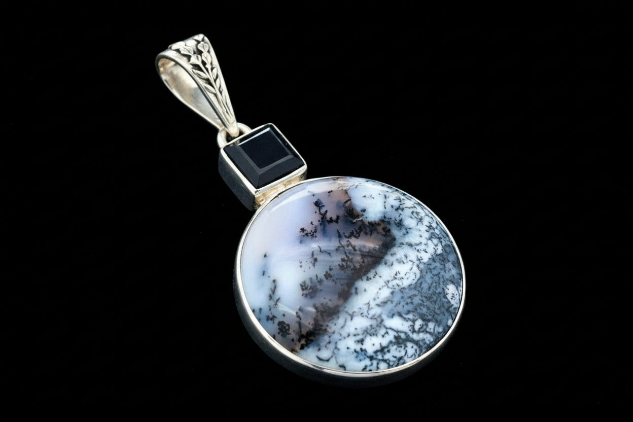 Merlinite and Black Spinel pendant back view showing the setting and bail