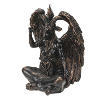 Statue of a winged creature with a horned head on a white background