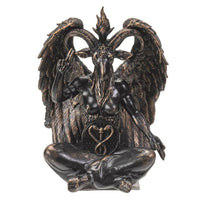 Bronze statue of a winged creature with a heart symbol on a white background