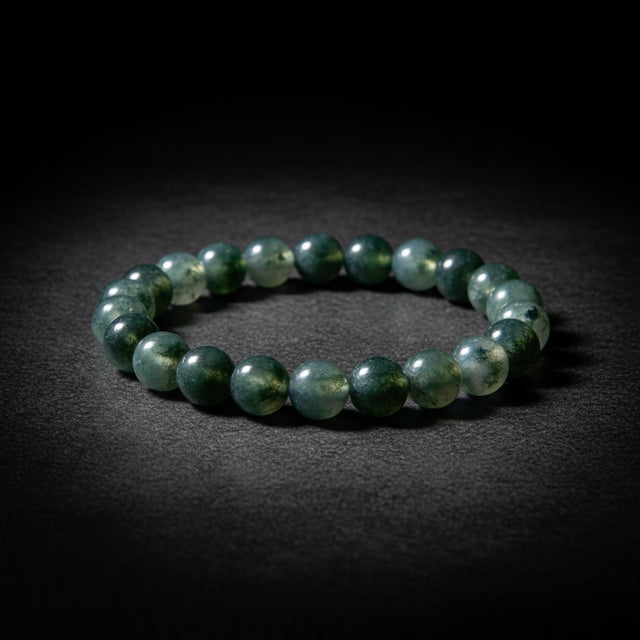 Representative beaded stretch bracelet sold as Moss Agate; chalcedony host, inclusion minerals, treatment, bead size, pattern, cord, fit, and exact condition vary