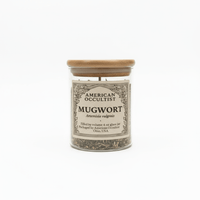 Jar of mugwort with a wooden lid on a white background