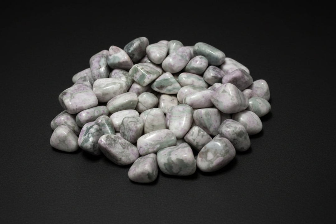 Polished pale-green, white, and cream stones sold as Peace Jade