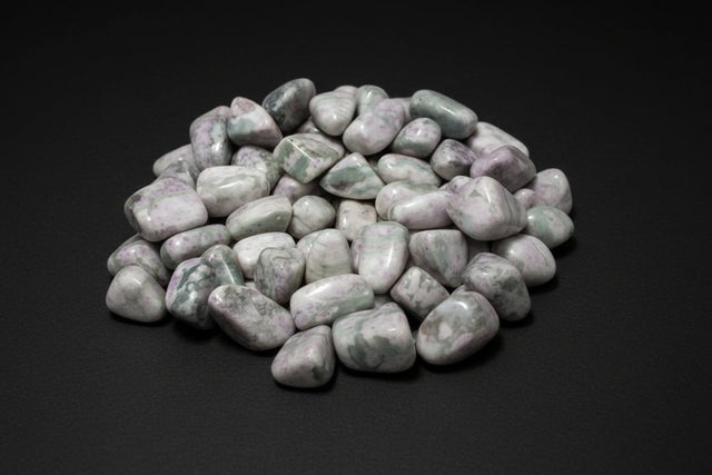 Polished pale-green, white, and cream stones sold as Peace Jade