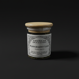 Dried cut-and-sifted peppermint leaf (Mentha × piperita) in a labeled glass ritual herb jar