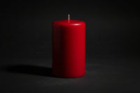 Red candle on a white background