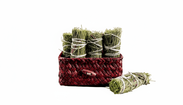 pine smoke cleansing wand in a basked on a white background.