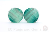 Pair of round green stone earrings on a white background with 'EC Plugs and Gems' branding.