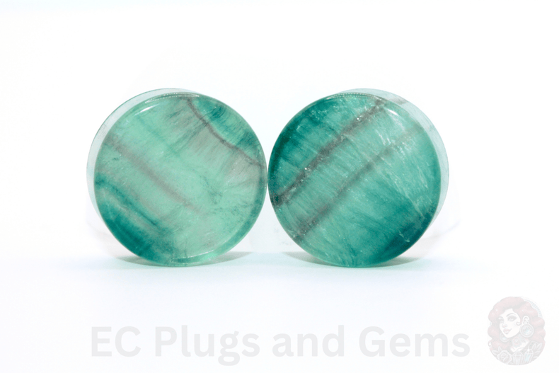 Pair of round green stone earrings on a white background with 'EC Plugs and Gems' branding.