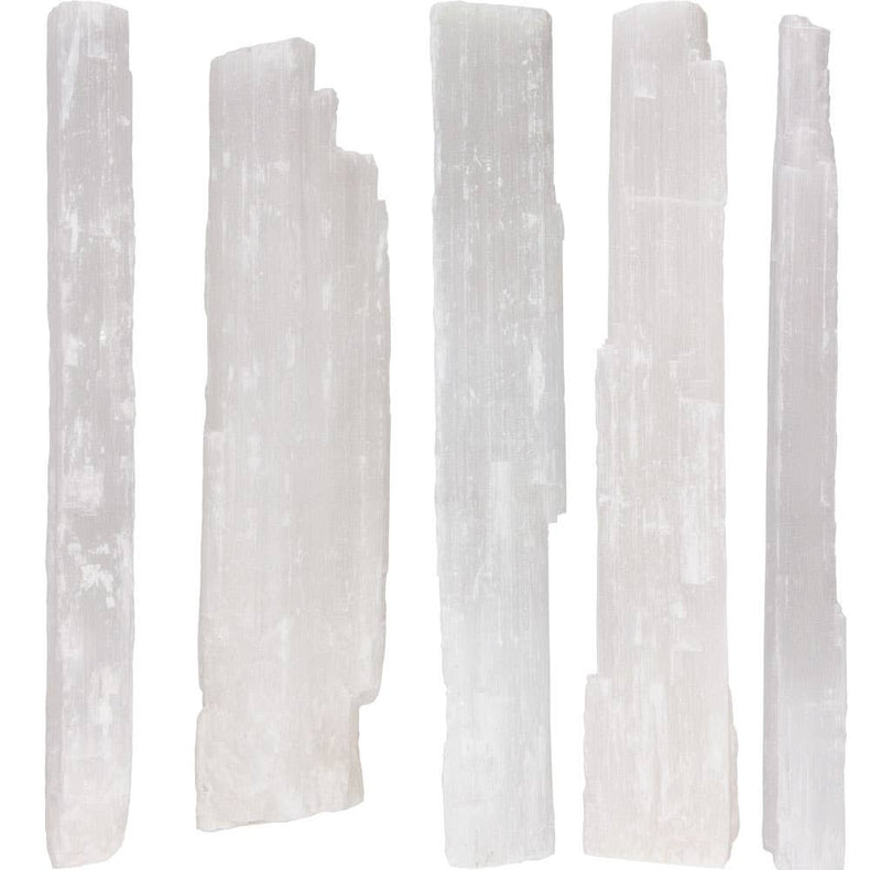 Set of six white selenite sticks on a white background