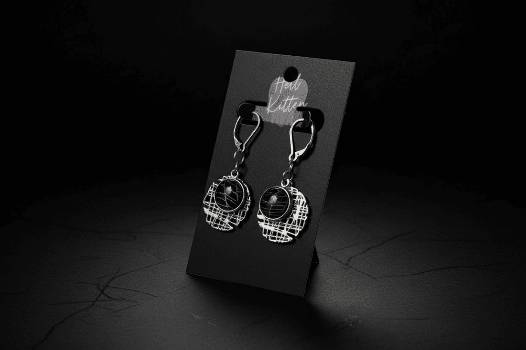 Geometric hash-style earrings containing preserved real spiderweb