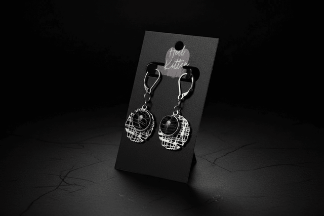 Geometric hash-style earrings containing preserved real spiderweb