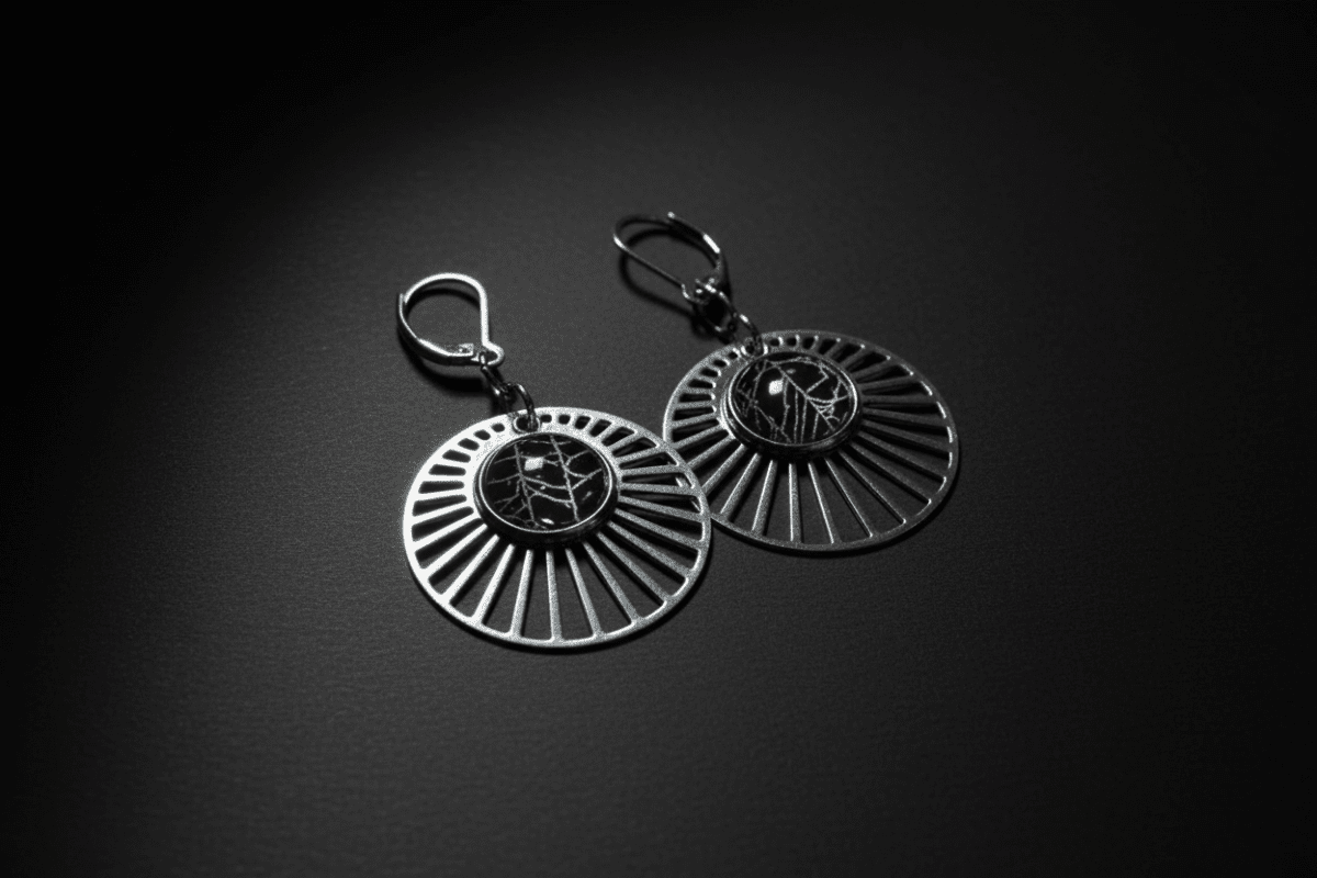 Silver-tone sunburst earrings containing preserved real spiderweb