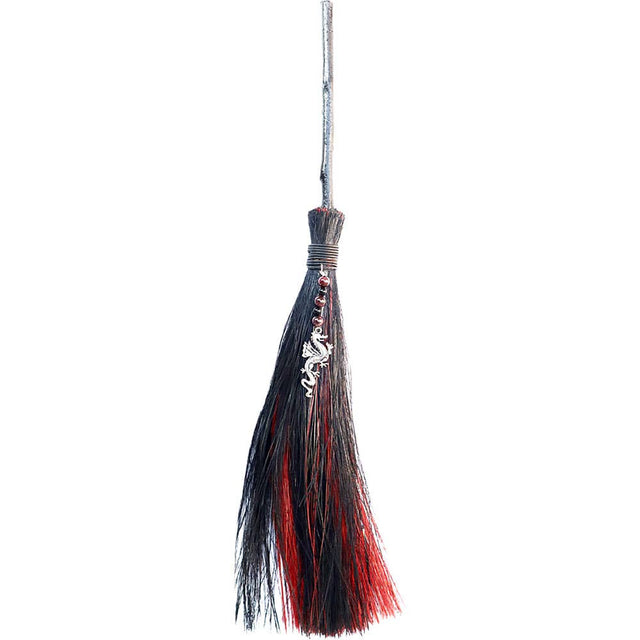 Broom with black and red bristles on a white background