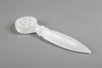 white selenite athame with a pentacle etched into the handle on a gray background.