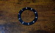Black ring with numbers on a wooden surface