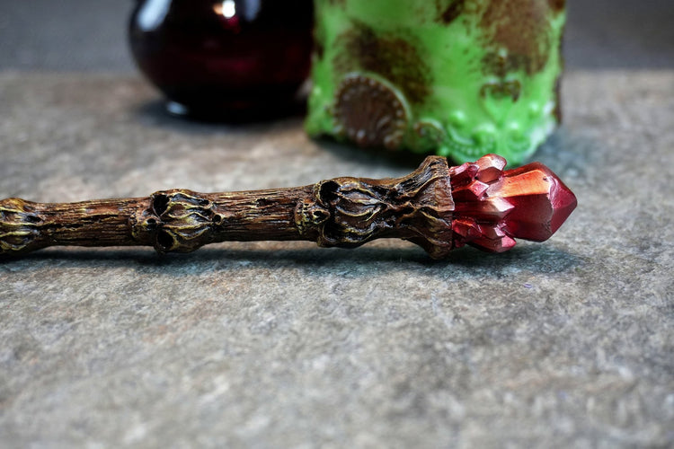 Skullroot Wand – Tree Trunk with Carved Skulls & Red Crystal