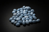 Representative assortment of small pale-blue Angelite trade stones; color, pattern, shape, and size vary