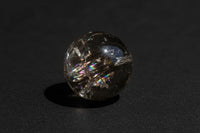 Representative polished smoky quartz mini sphere with smoky translucence, internal fractures, and possible rainbow-like flashes