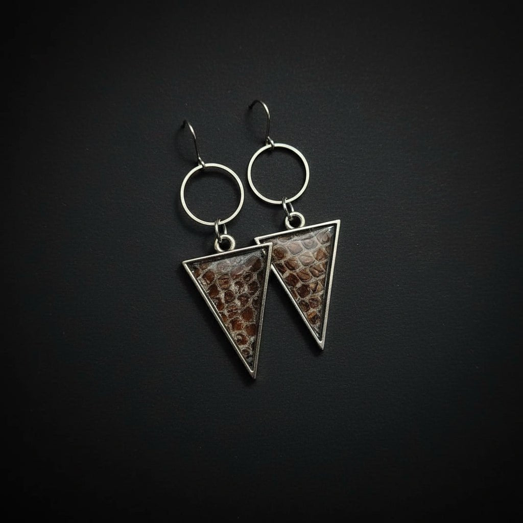 Triangle earrings featuring ethically sourced snake shed